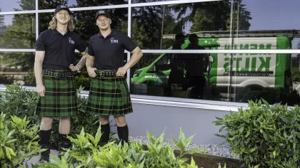 two people wearing kilts