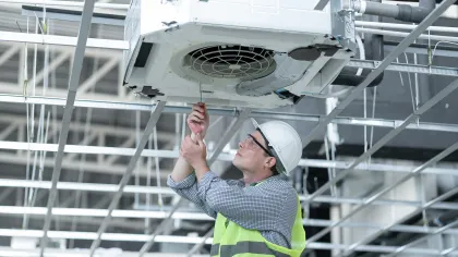 a man in a safety vest holding a white object