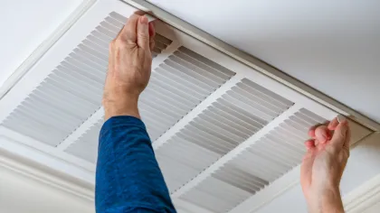 a person's hands reaching towards a ceiling