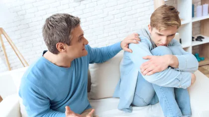 a man sitting with his son