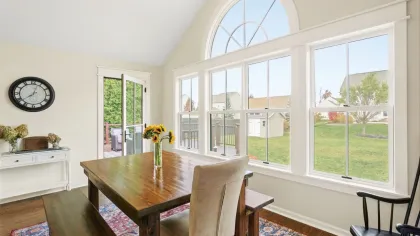 North Georgia Replacement Windows Laminated glass to reduce outside noise - round top window in white near dining table