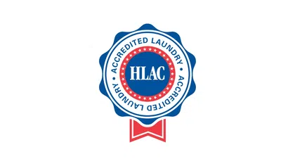 HLAC Accredited Laundry badge with blue, red, and white colors and a ribbon at the bottom