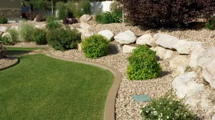a small garden with rocks and grass