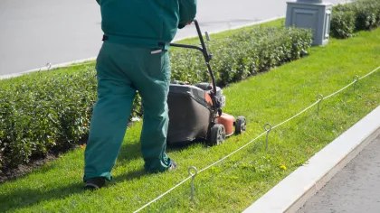 a person pulling a lawn mower