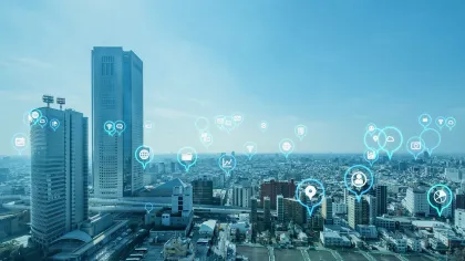 A city skyline featuring tech icons and connectivity symbols in a digital landscape.