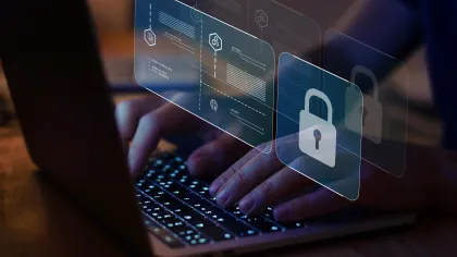 Person typing on a laptop with digital security icons floating above.