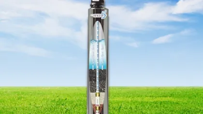 Water filtration system cylinder showing internal layers against a blue sky and green grass background