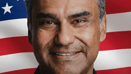 Portrait of Nadeem Azhar with American flag background and text Coming to America