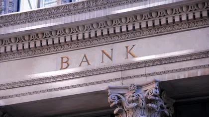 Close-up of ornate bank building facade with decorative stonework and the word BANK engraved above entrance.