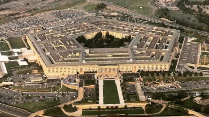 Aerial view of the Pentagon building surrounded by roads and parking lots in Arlington, Virginia.