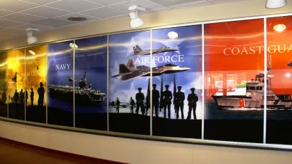Wall mural featuring US Marines, Navy ship, Air Force jets, and Coast Guard boat with silhouetted personnel.
