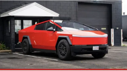 a red car parked in front of a garage