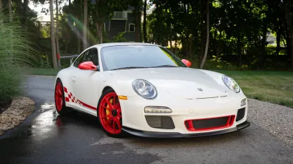 a white sports car parked on a driveway