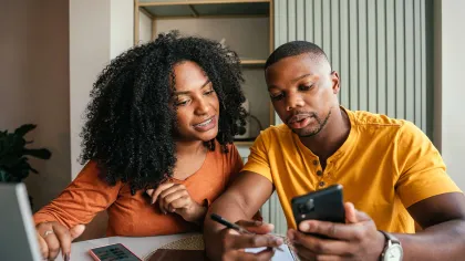 a man and a woman looking at a phone