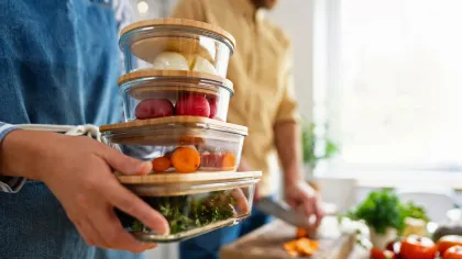 a person holding a jar of food