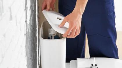 a person opening a toilet