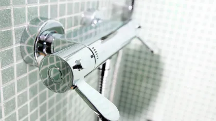 a shower head with a glass door