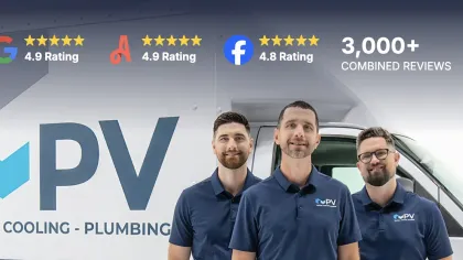 Three men in company shirts stand in front of PV Heating Cooling Plumbing van with high customer ratings shown.