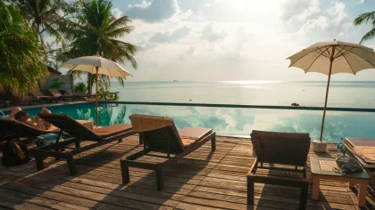 a deck with chairs and umbrellas by the water