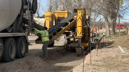a person standing next to a large machine