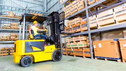 a person driving a forklift