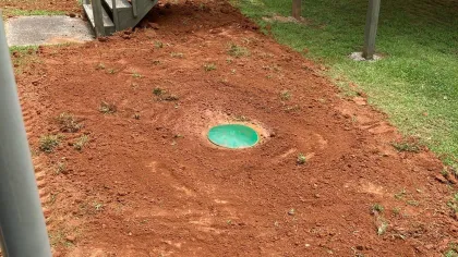 a green septic tank in the ground being inspected in Metro Atlanta and surrounding areas