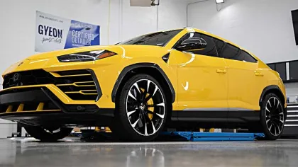 Yellow Lamborghini Urus luxury SUV parked indoors highlighting sleek design and black accents