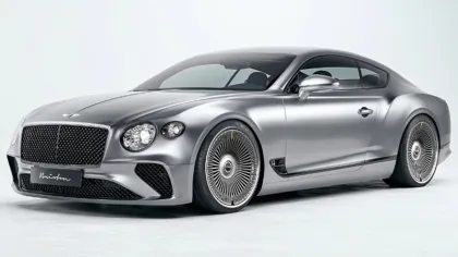 Sleek silver luxury sports coupe with intricate alloy wheels and modern aerodynamic design isolated on white background