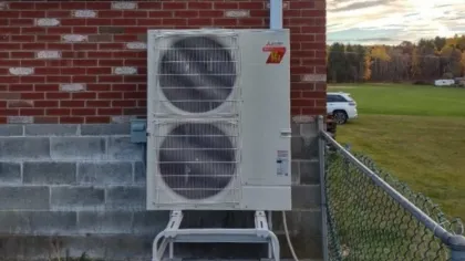 a large white machine outside a building