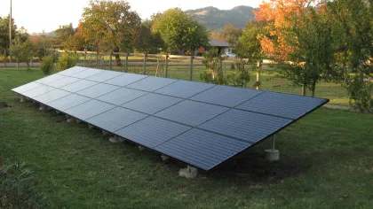 a solar panel on a grass field