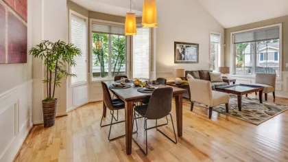 a large living room with a large dining table and chairs