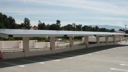 a parking lot with a white building