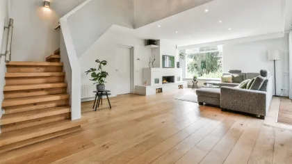 a large living room with wood floors