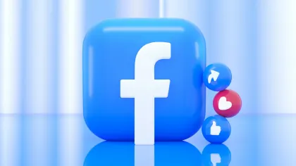 Blue Facebook logo cube with social media reaction icons for share, love, and like on reflective surface.