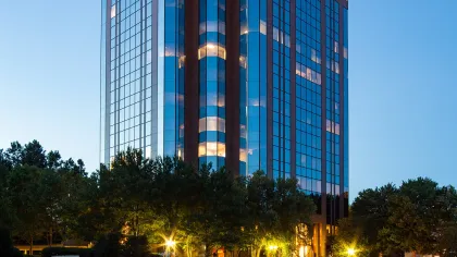 a tall building with trees in front of it