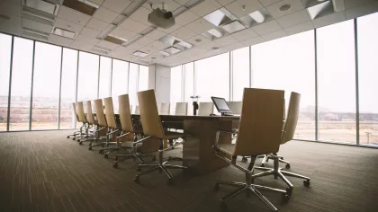a room with a desk and chairs