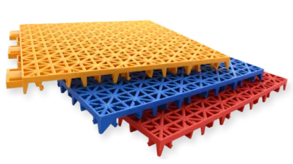 Stacked interlocking yellow, blue, and red plastic floor tiles with a triangular grid pattern.