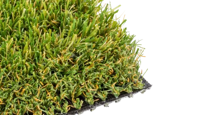 Close-up of realistic artificial grass with vibrant green blades and a black backing material.