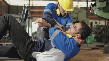 a person in a hard hat talking to a person in a blue shirt