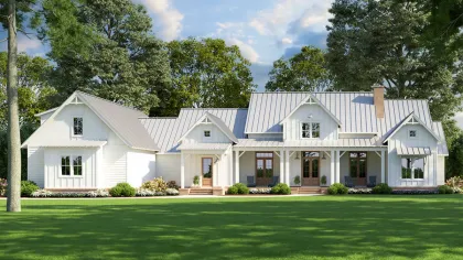 a large white house with a green lawn