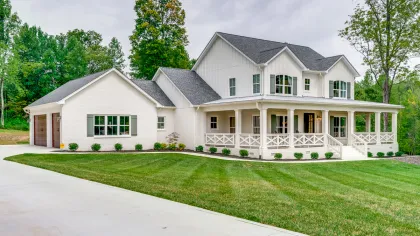 a large white house with a lawn