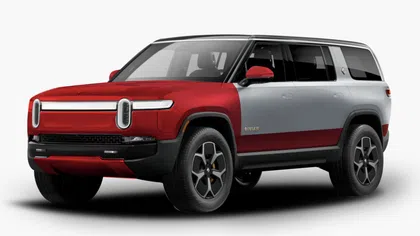 Side front view of a red and silver Rivian electric SUV with modern design and black wheels.