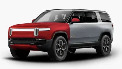 Two-tone red and silver Rivian electric SUV with modern LED headlights and black wheels on a white background
