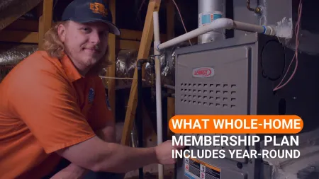 Estes Services Technician servicing Lennox furnace in attic promoting whole-home membership plan with year-round coverage.