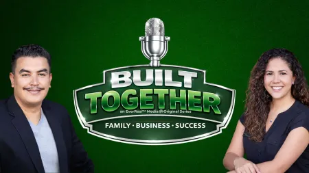 Two hosts smiling on each side of a Built Together podcast logo with a microphone on a green background