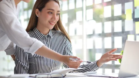 a woman looking at a laptop