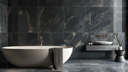 Modern bathroom with freestanding white tub, dark marble walls, floating concrete sink, and minimalist decor.