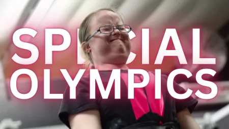 Athlete with glasses showing determination and strength with Special Olympics text overlay in background.