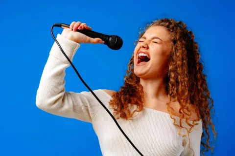 a person singing into a microphone