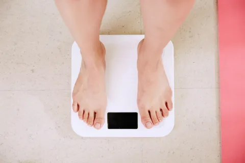 obese senior on scale